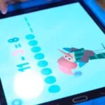 A child uses a tablet to solve a subtraction problem in one of the free math games online designed for early learners