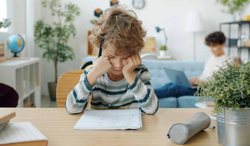 Kid solving math problem for a homework