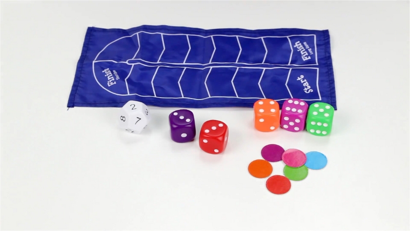 Math Dice game pieces, colorful chips, and a blue game mat are arranged on a white surface, ready for a fun math challenge