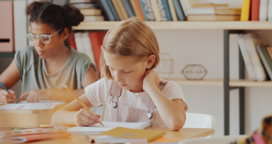 Girl solving math exercise during the school class