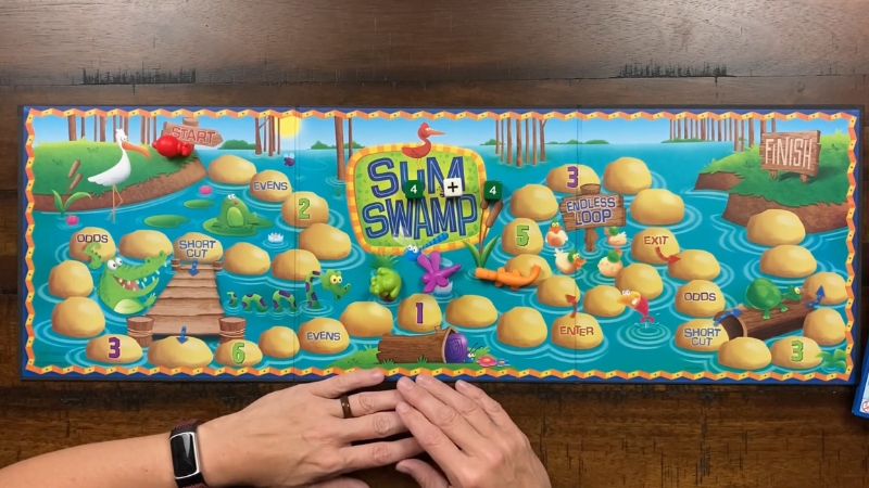 A colorful Sum Swamp game board sits on a table