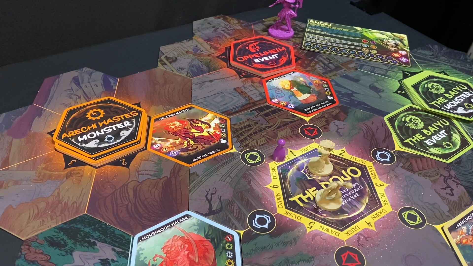 Colorful board game layout from Champions of Hara with cards, tokens, and miniatures on hex tiles