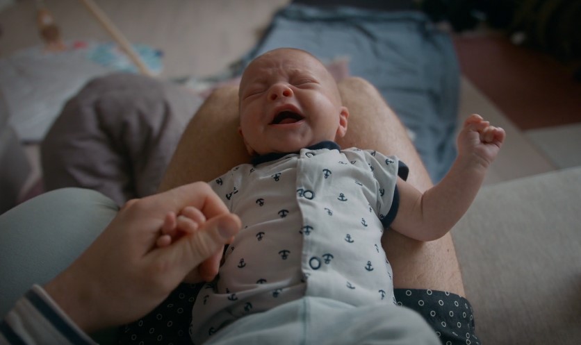 Baby crying while mother is taking care