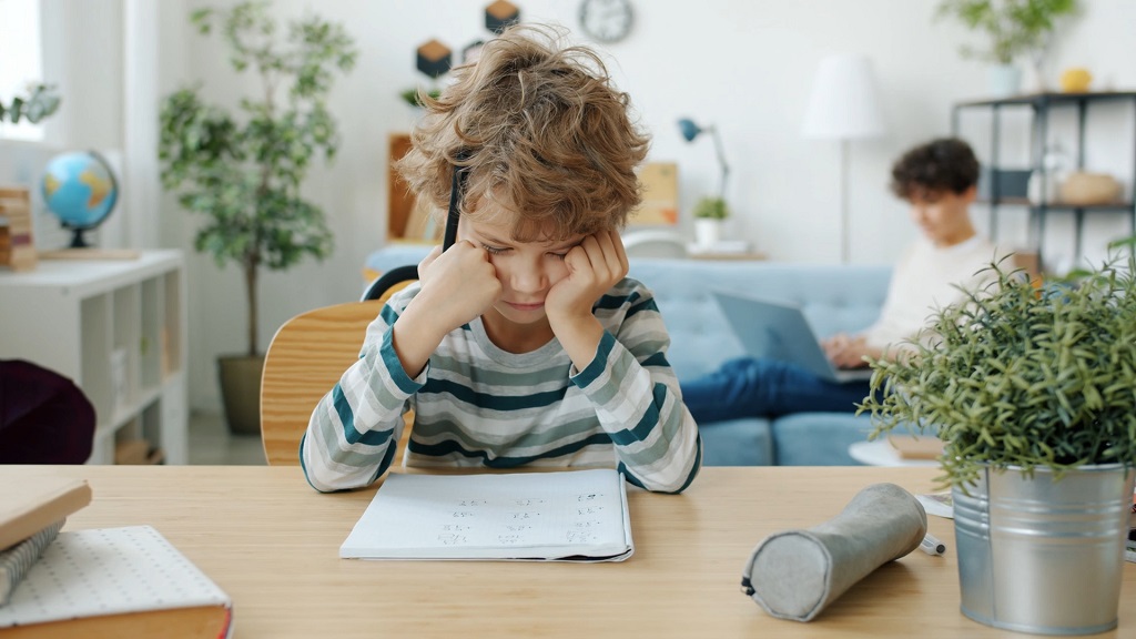 Child reading a picture book aloud in a colorful learning space