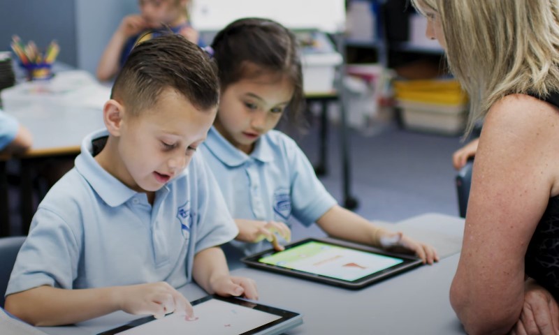 Young learners engrossed in tablet activities