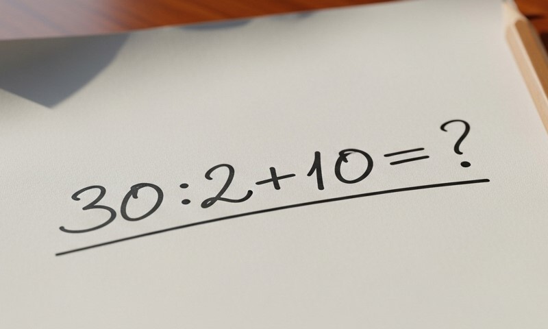 Handwritten math problem on white paper: 30 divided by 2 plus 10 equals question mark