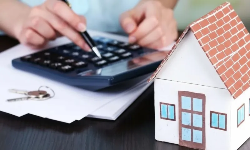 Person using calculator as part of house-buying plans