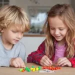 Two young children sorting colorful pieces at a table indoors