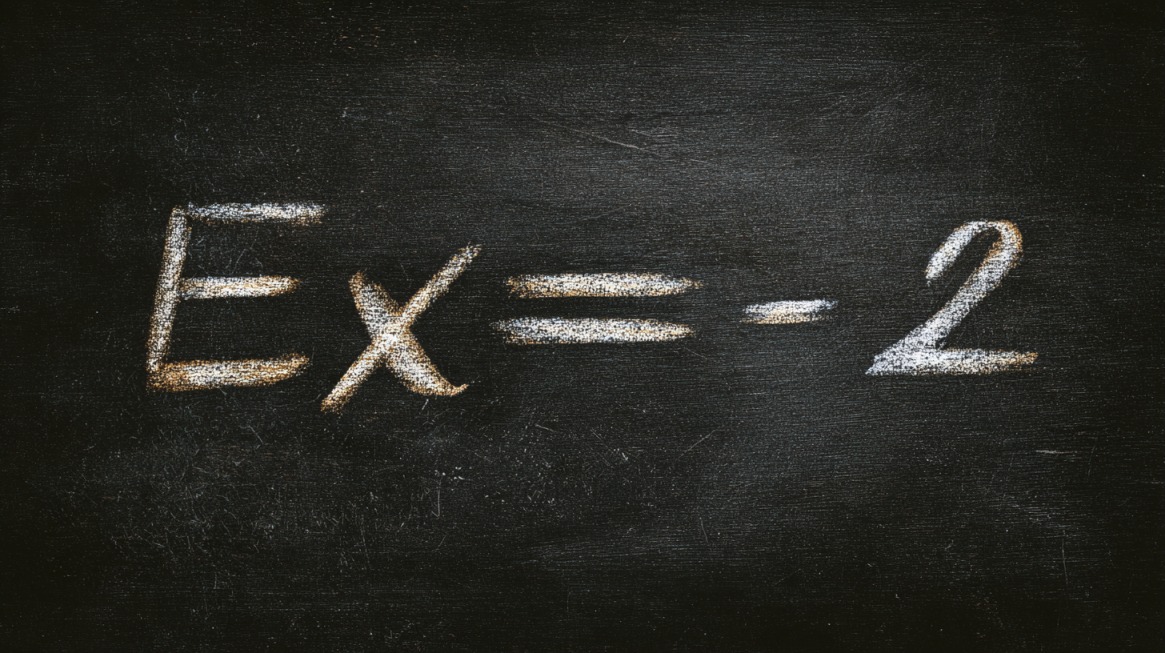 Chalkboard showing the equation Ex equals minus 2 written in white chalk